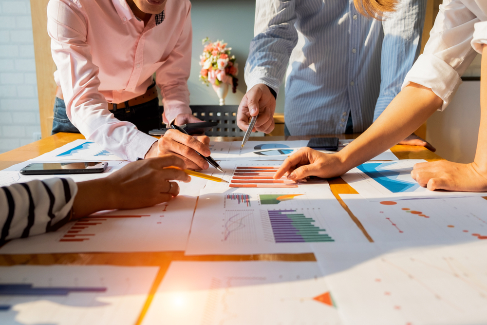 Hands reviewing financial documents. UK millionaire exodus 2025 tax changes